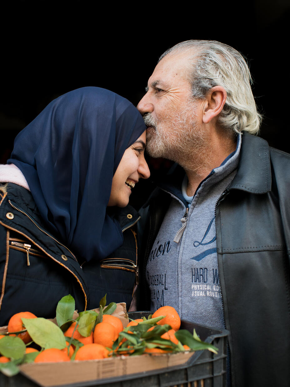 Ala'a's father kisses her forehead.